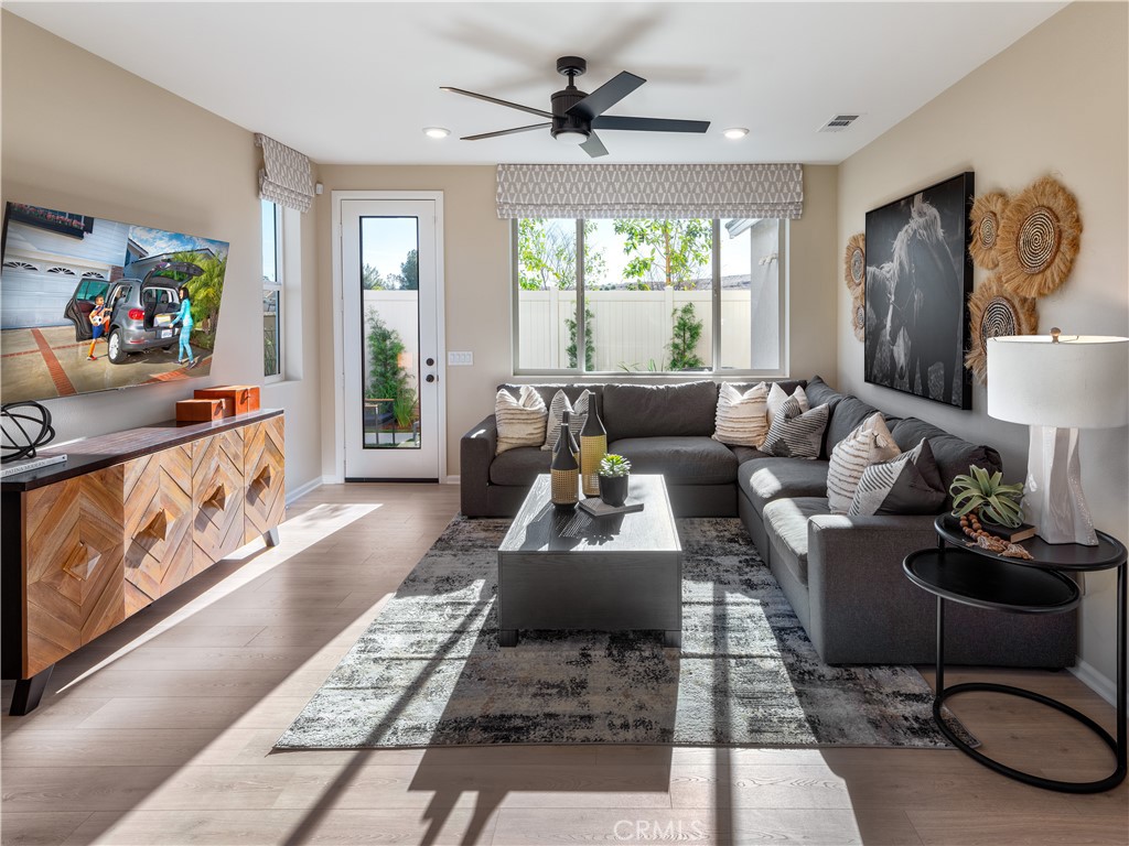 7176 Squall Drive Riverside, CA 92503 - Photo 5 of 15 a living room with furniture and a flat screen tv