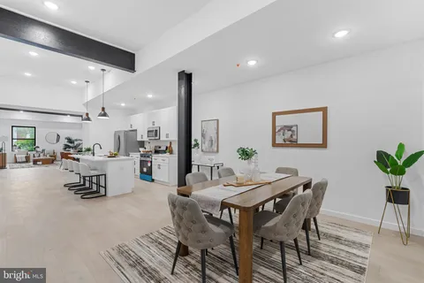 a dining room with furniture and wooden floor