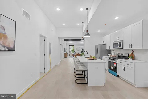 a kitchen with stainless steel appliances a sink stove and refrigerator