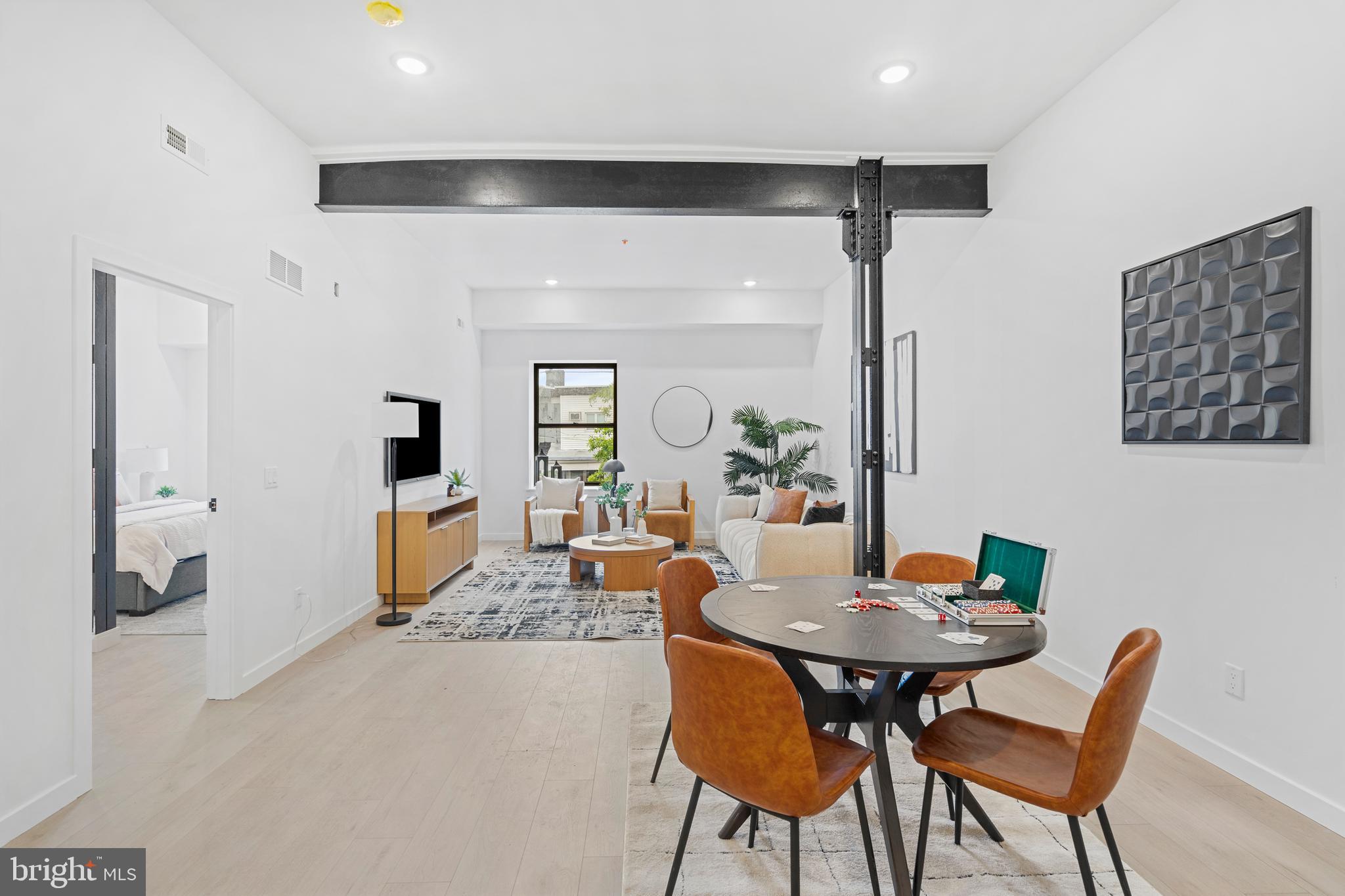 3211 Cedar Street, Unit 2002 Philadelphia, PA 19134 - Photo 8 of 19 a view of a dining room and livingroom with furniture wooden floor and a rug