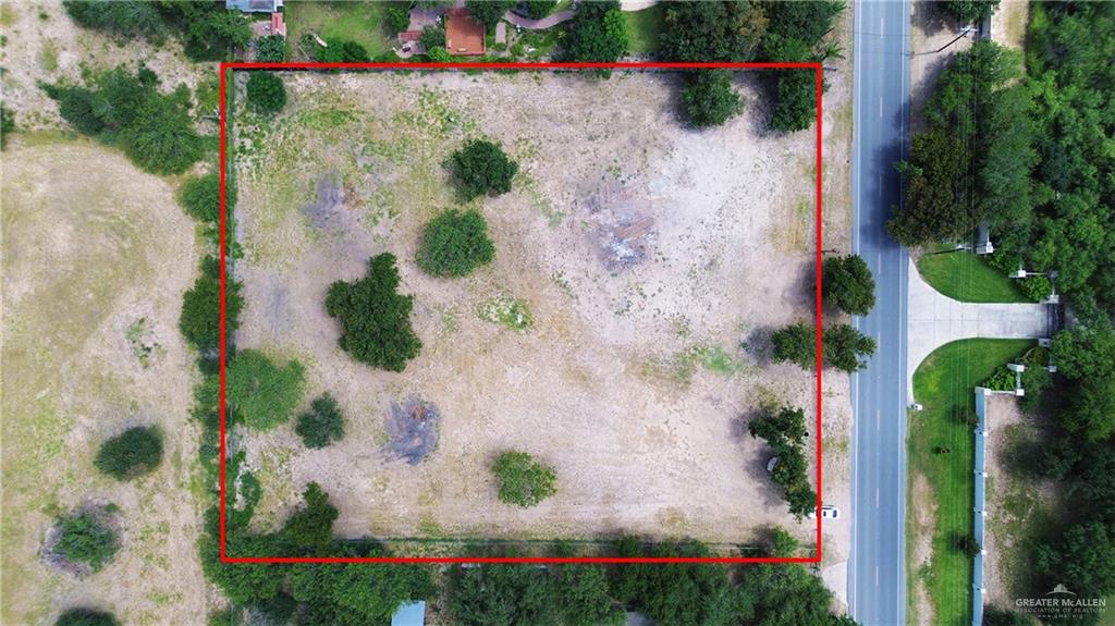 6901 North Taylor Road Mission, TX 78573 - Photo 5 of 5 an aerial view of a house with a yard and a wooden fence