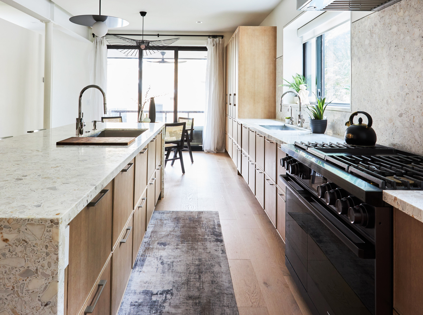 2039 North Humboldt Boulevard Chicago, IL 60647 - Photo 13 of 49 a kitchen with kitchen island a counter space a sink a stove and a dining table with wooden floor