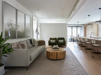 a living room with furniture rug and a table