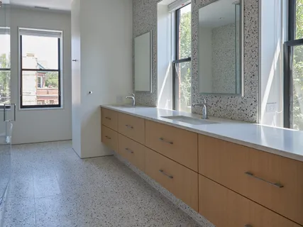 a bathroom with a double vanity sink a shower and a mirror