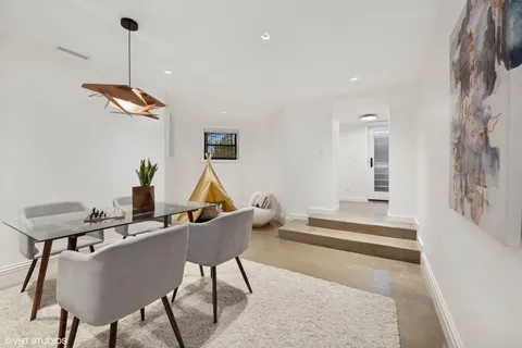 a bathroom with a toilet a sink a mirror a bathtub and vanity