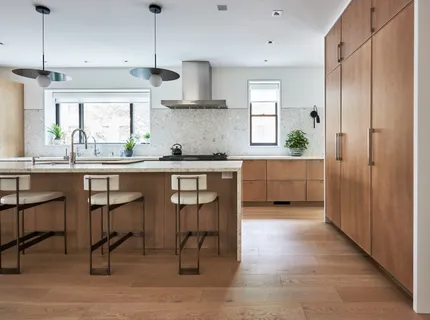 a kitchen with stainless steel appliances granite countertop a table chairs sink and cabinets