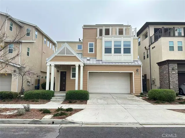 a front view of a house with yard and garage