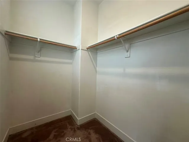 a view of empty room with windows and cabinet