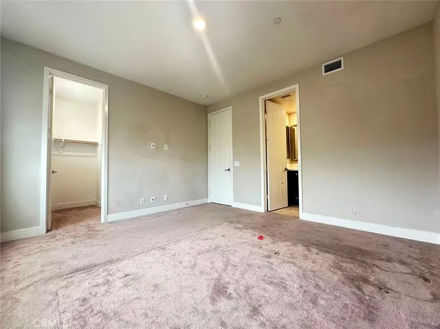 an empty room with closet and bathroom
