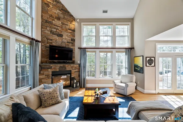 a living room with furniture a fireplace and a flat screen tv