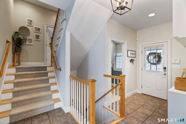 a view of entryway and hall with a front door