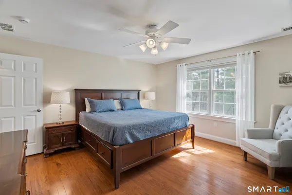a spacious bedroom with a bed and a couch