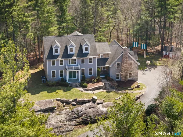 a view of a house with swimming pool in front of it