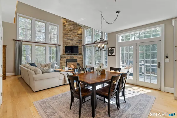 a view of a dining room with furniture wooden floor and a chandelier