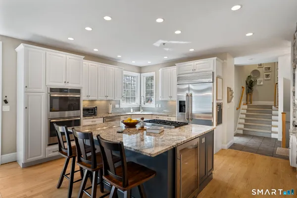 a kitchen with stainless steel appliances granite countertop a stove and a refrigerator