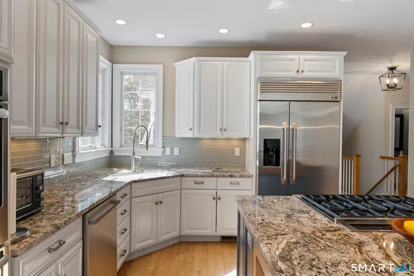 a kitchen with a sink stove and refrigerator