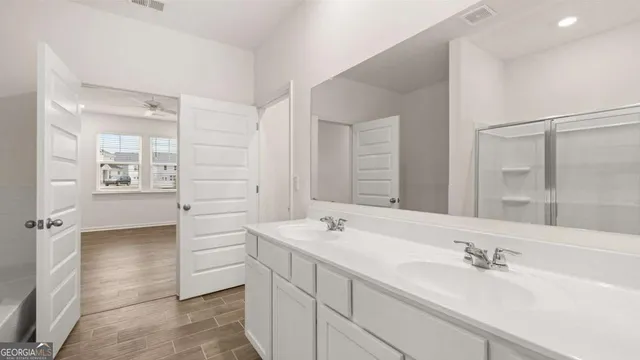 a bathroom that has a glass shower door