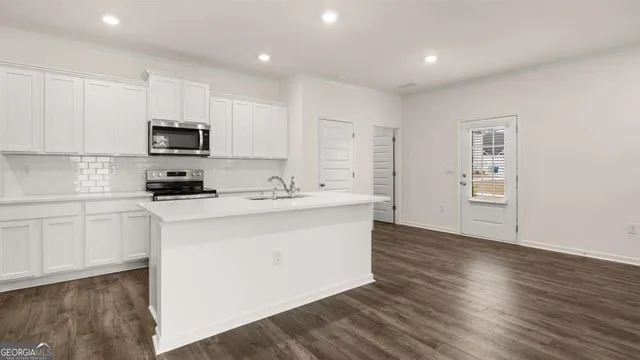 a kitchen with stainless steel appliances granite countertop a sink and cabinets