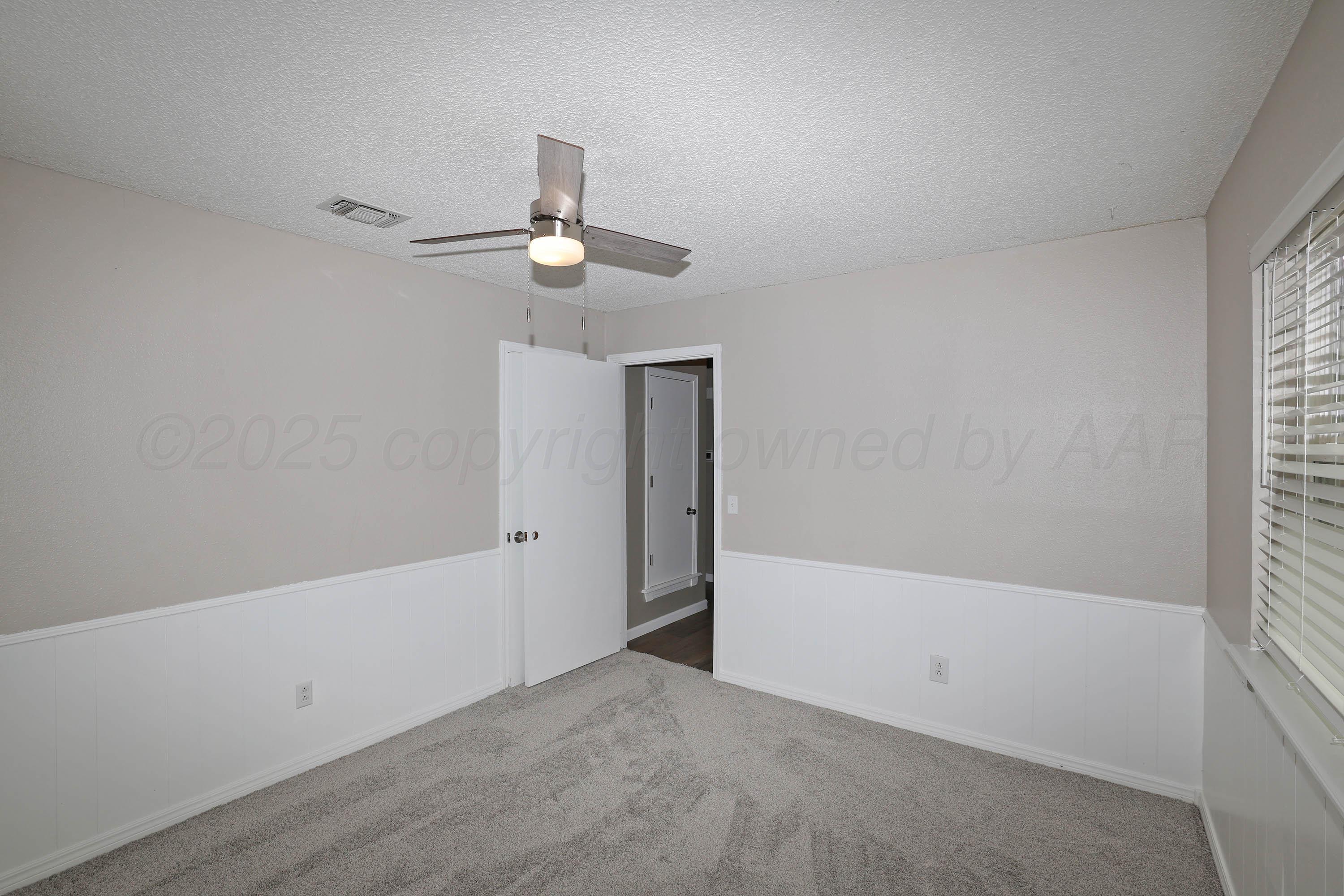 7426 Jameson Drive Amarillo, TX 79121 - Photo 26 of 38 wooden floor in an empty room with a window