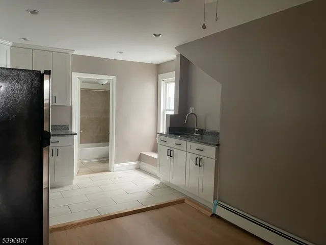 a spacious bathroom with a granite countertop sink and a mirror