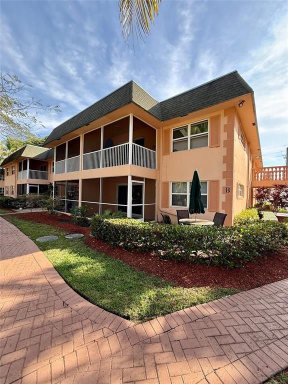 760 Southeast 2nd Avenue, Unit D112 Deerfield Beach, FL 33441 - Photo 1 of 7 a front view of a house with a yard