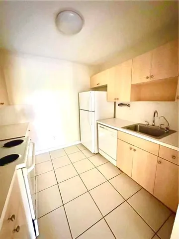 a kitchen with a sink cabinets and appliances