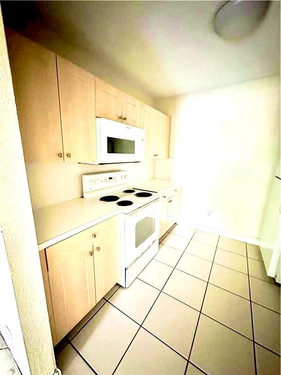 760 Southeast 2nd Avenue, Unit D112 Deerfield Beach, FL 33441 - Photo 4 of 7 a kitchen with granite countertop a sink and a stove top oven