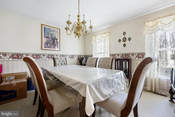 a kitchen with stainless steel appliances granite countertop a sink dishwasher stove and wooden cabinets with wooden floor