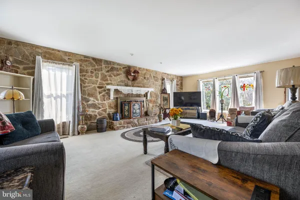 a kitchen with stainless steel appliances granite countertop a refrigerator a stove and a sink with cabinets