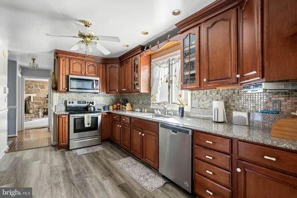 a living room with patio furniture and a potted plants