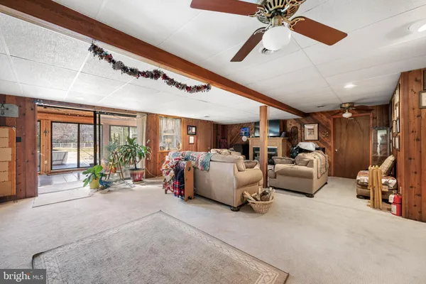 a view of a roof deck with wooden floor and fence next to a yard
