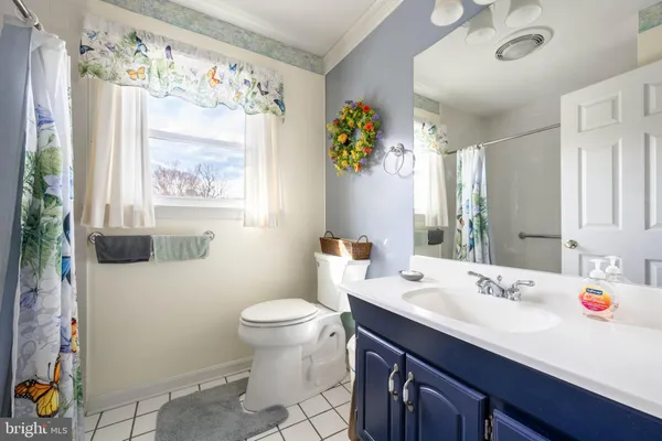 a kitchen with stainless steel appliances kitchen island granite countertop a refrigerator and a microwave