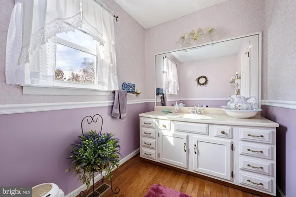 a front view of a house with a yard covered with snow