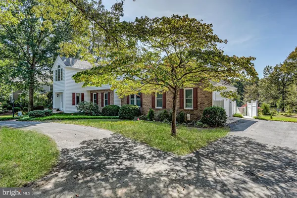 a front view of a house with a yard and a garden