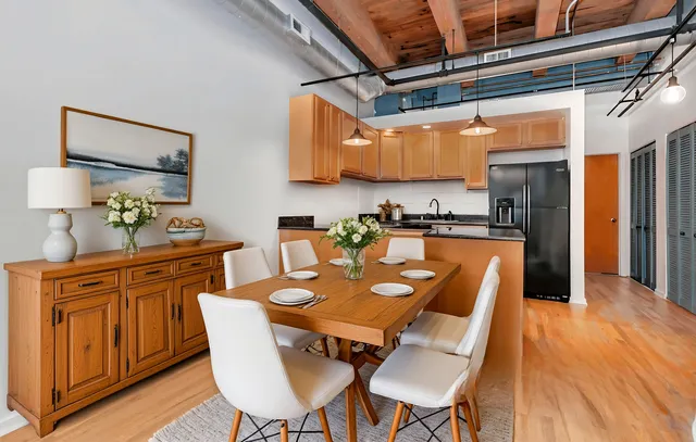 a view of a dining room with furniture wooden floor and a chandelier