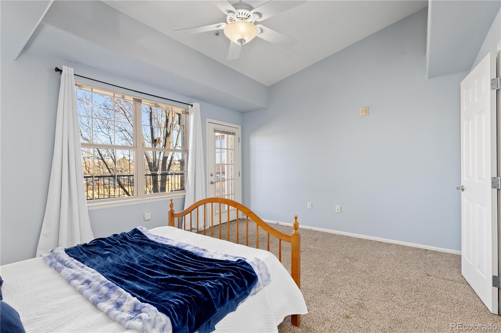 10841 Twenty Mile Road, Unit 206 Parker, CO 80134 - Photo 12 of 27 a bedroom with a bed and a window