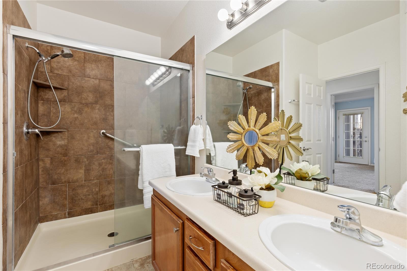 10841 Twenty Mile Road, Unit 206 Parker, CO 80134 - Photo 15 of 27 a bathroom with a sink vanity granite tub shower and a mirror