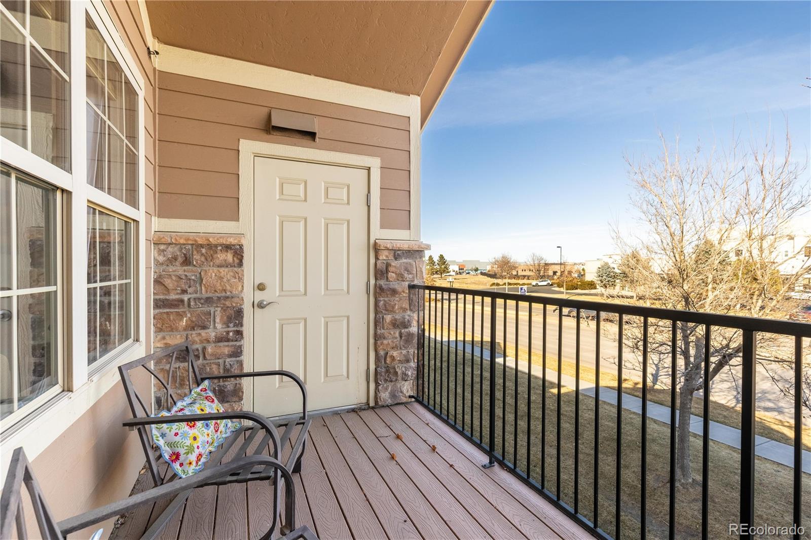 10841 Twenty Mile Road, Unit 206 Parker, CO 80134 - Photo 17 of 27 a view of a balcony with wooden floor