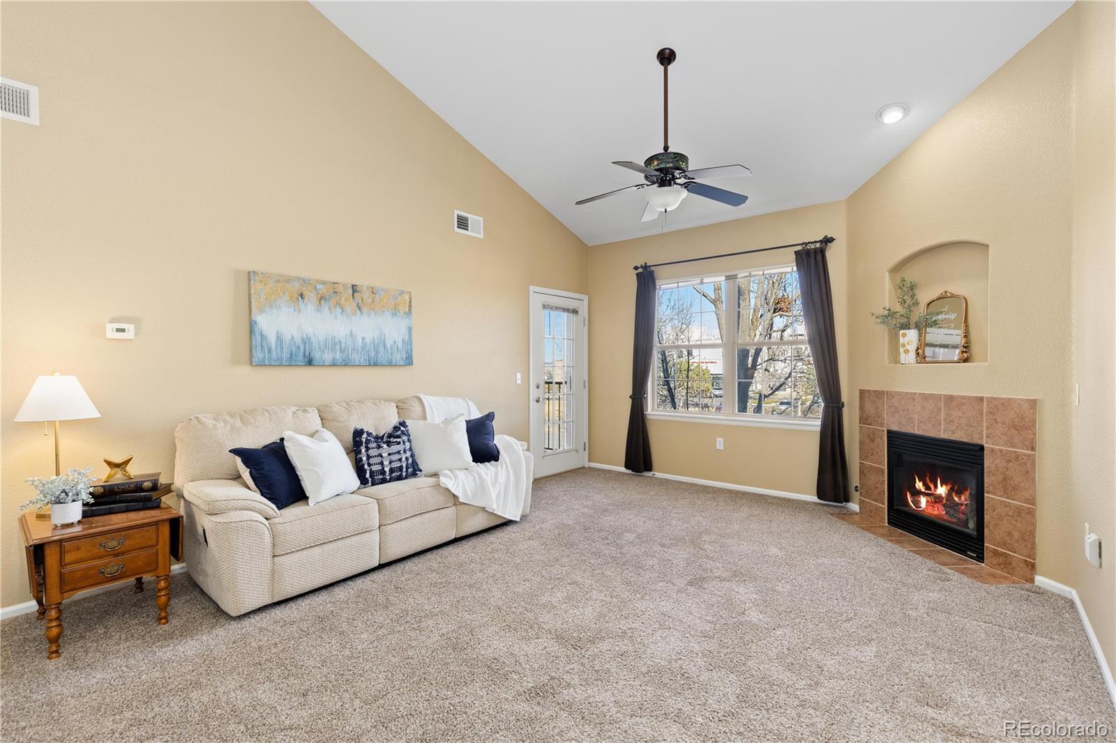 10841 Twenty Mile Road, Unit 206 Parker, CO 80134 - Photo 6 of 27 a living room with furniture and a fireplace