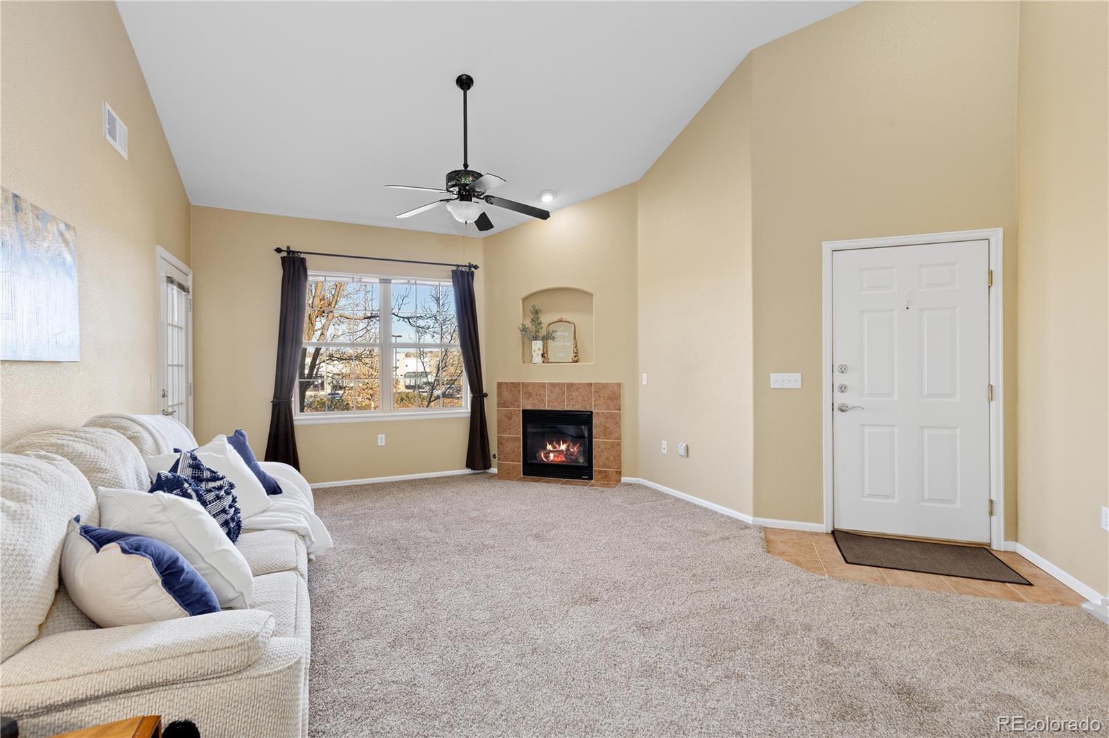 10841 Twenty Mile Road, Unit 206 Parker, CO 80134 - Photo 7 of 27 a view of livingroom with furniture window and fireplace