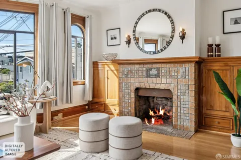 a living room with furniture a large window and a fireplace