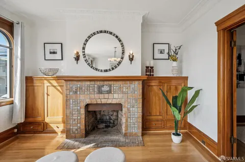 a kitchen with stainless steel appliances granite countertop a stove top oven a sink a dining table and chairs