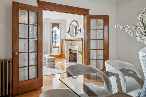 a bedroom with a bed and painting on the wall