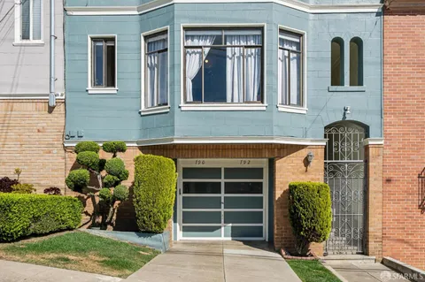 a view of hallway with wooden floor and stairs