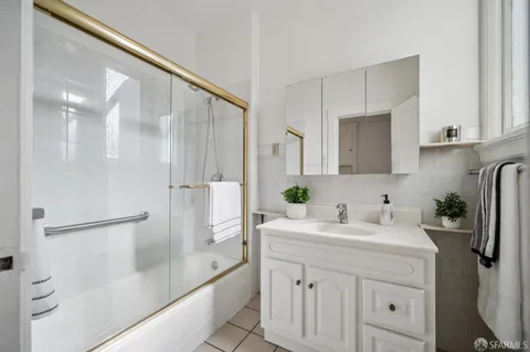 a bathroom with a double vanity sink and a mirror