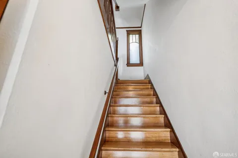 a living room with furniture a fireplace and a large window