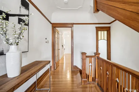 a living room with furniture a fireplace and a large window