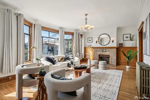 a living room with furniture and a chandelier