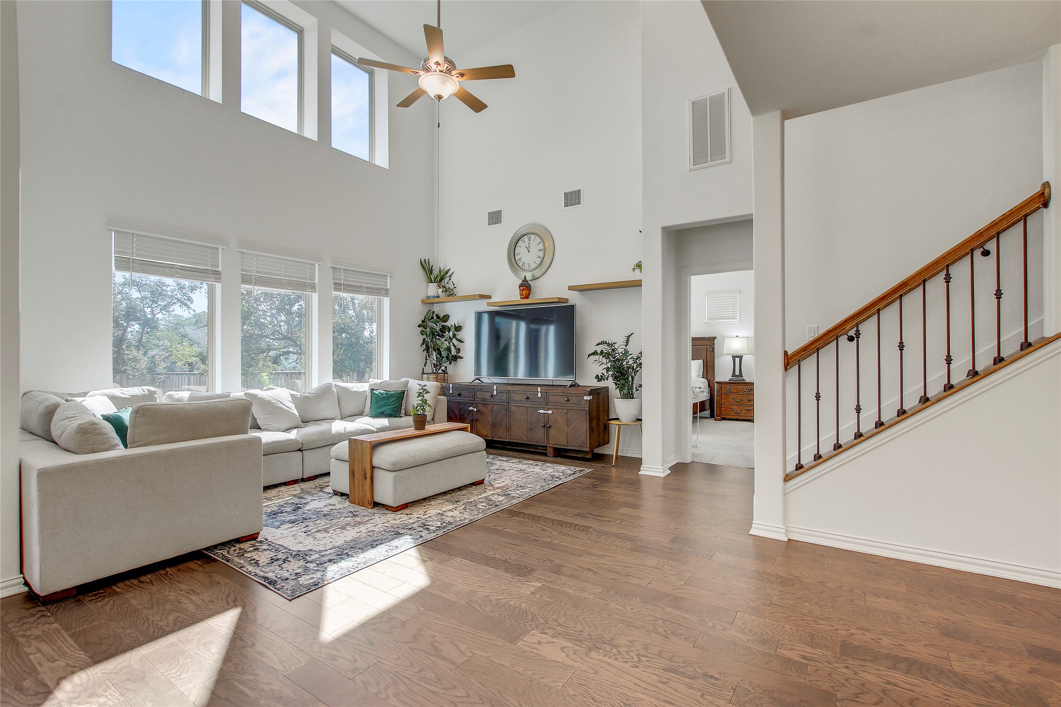 104 Millbend Road Georgetown, TX 78633 - Photo 16 of 40 Natural light floods this living space, highlighting its generous proportions and gleaming wood flooring.