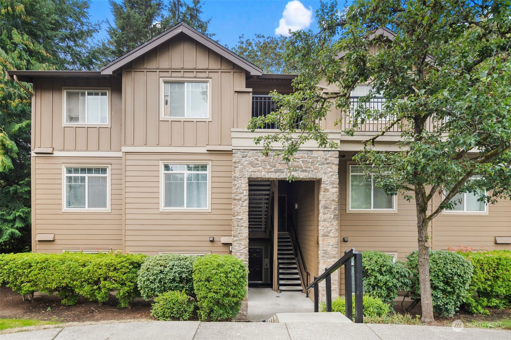 18930 Bothell Everett Highway, Unit C101 Bothell, WA 98012 - Photo 1 of 36 a front view of a house with garden